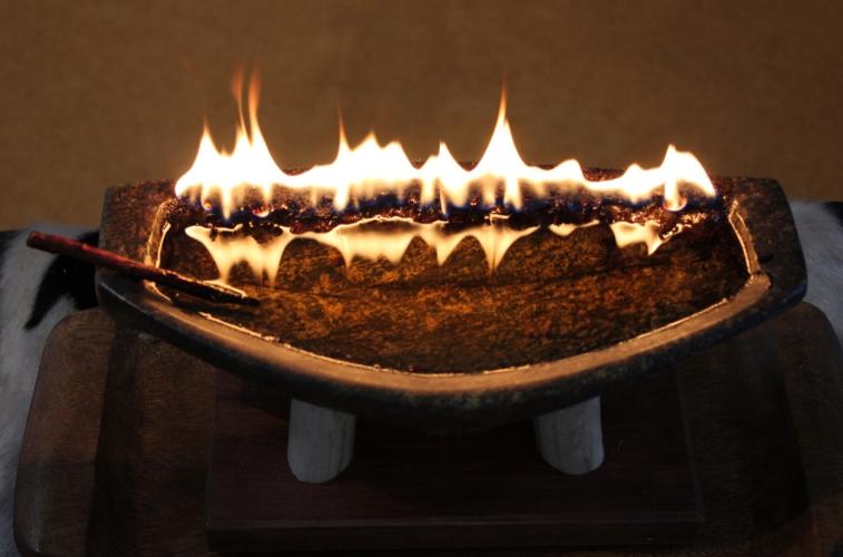Soapstone qulliit, with flames. Nick Newbery fonds / Nunavut Archives/ [Culture. Qulliit 1977-2004. 18. Qulliit. Iqaluit – Soapstone qulliq. Shorty Shoo 2003].