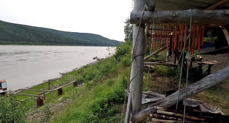 Salmon dry in a covered fish rack beside the Yukon River.